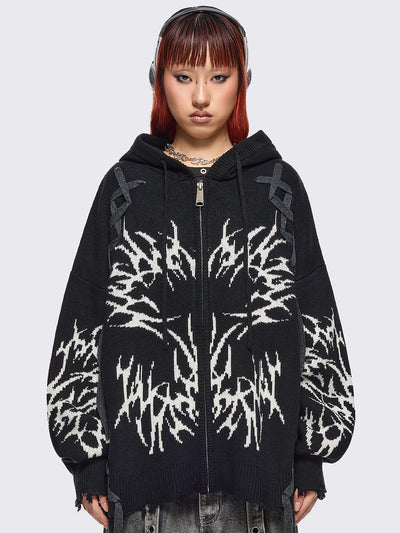 Black hooded chunky knit cardigan featuring white sigilism graphic design, contrast grey lace up details and distressed trims.