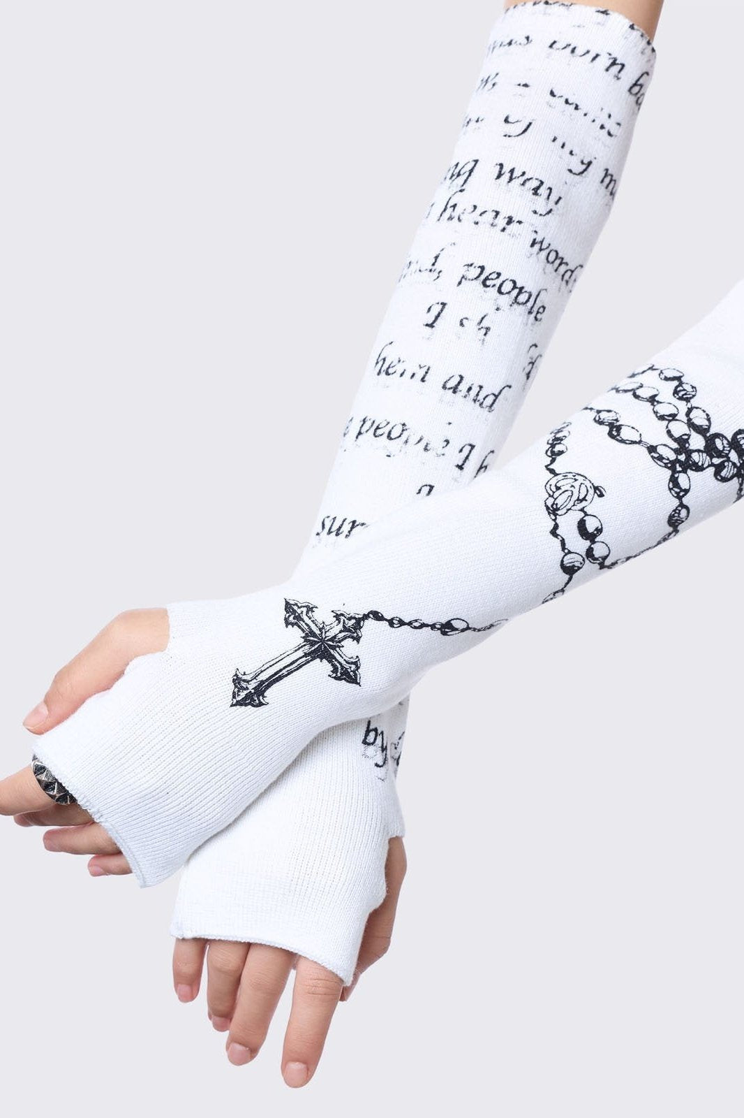 White knitted arm warmers with rosary and text graphic print.