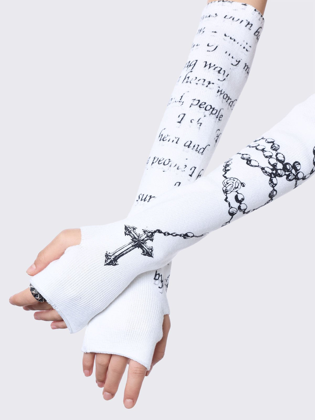 White knitted arm warmers with rosary and text graphic print.