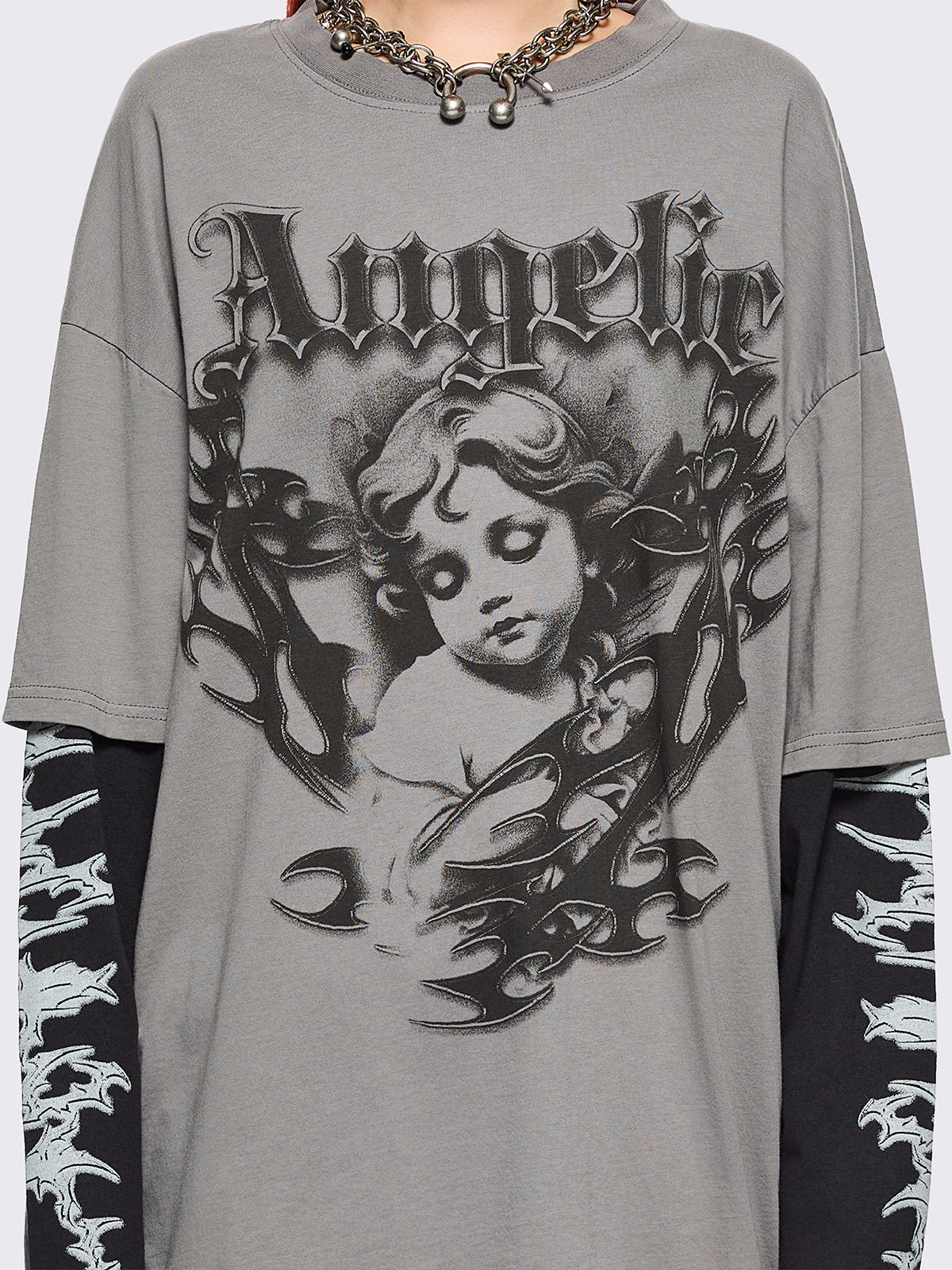 Grey layered long sleeve t-shirt with angelic graphic front print and contrast black sleeves with sigilism print.