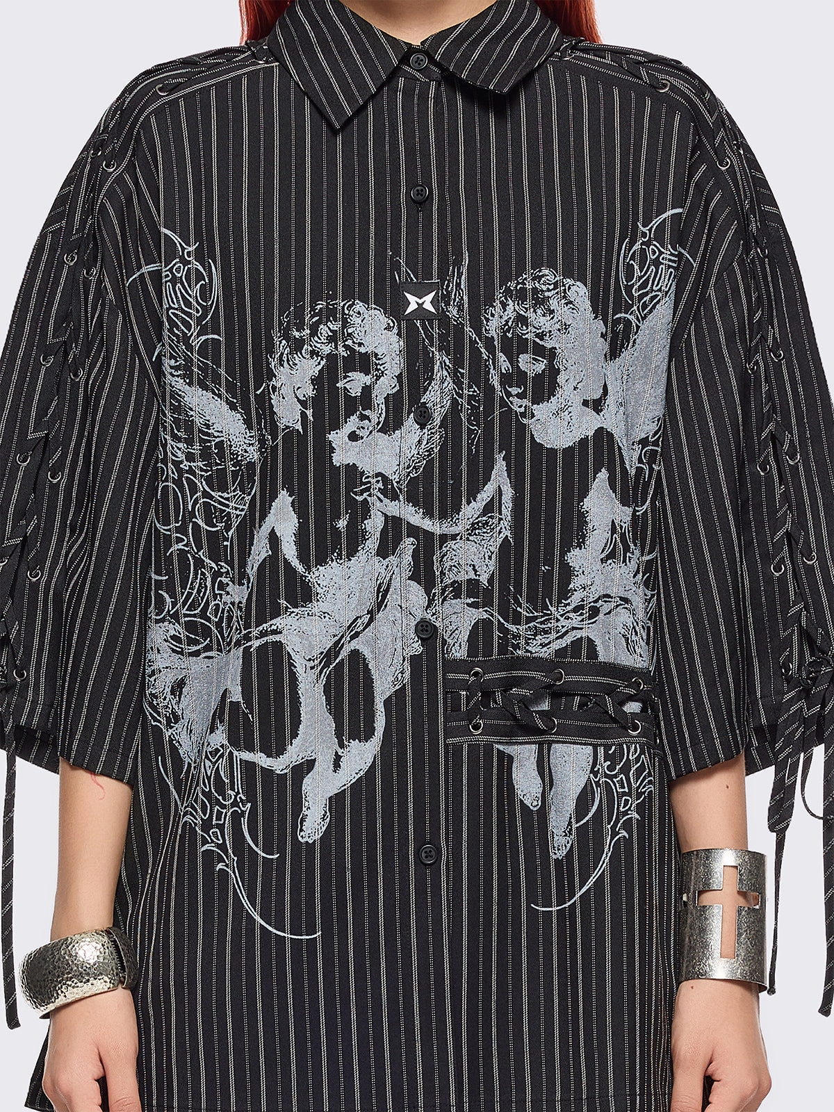 Black pinstriped shirt with white angels graphic front print and laced up details.