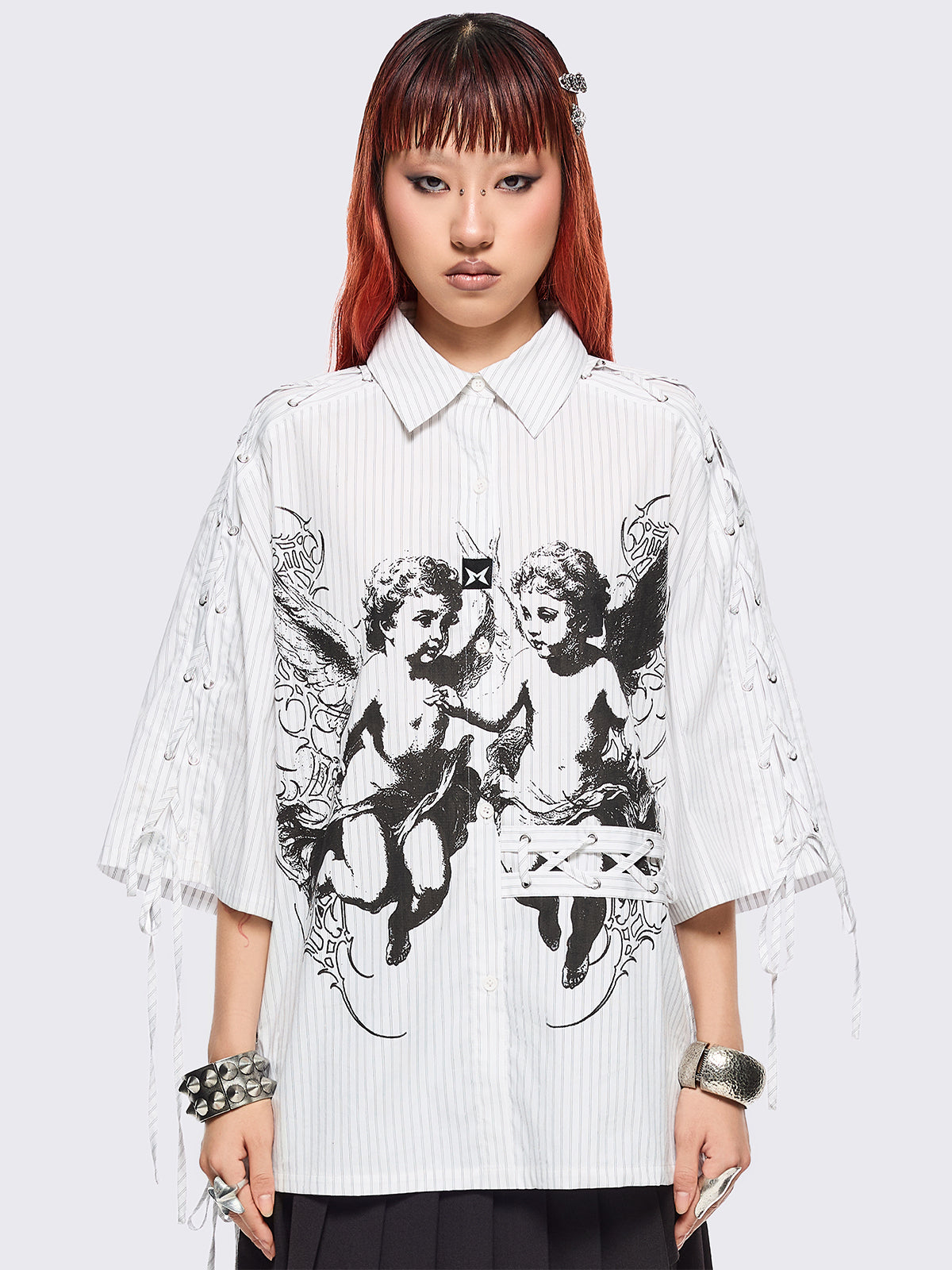 White striped short sleeve shirt featuring a black angels graphic front print and laced up details.