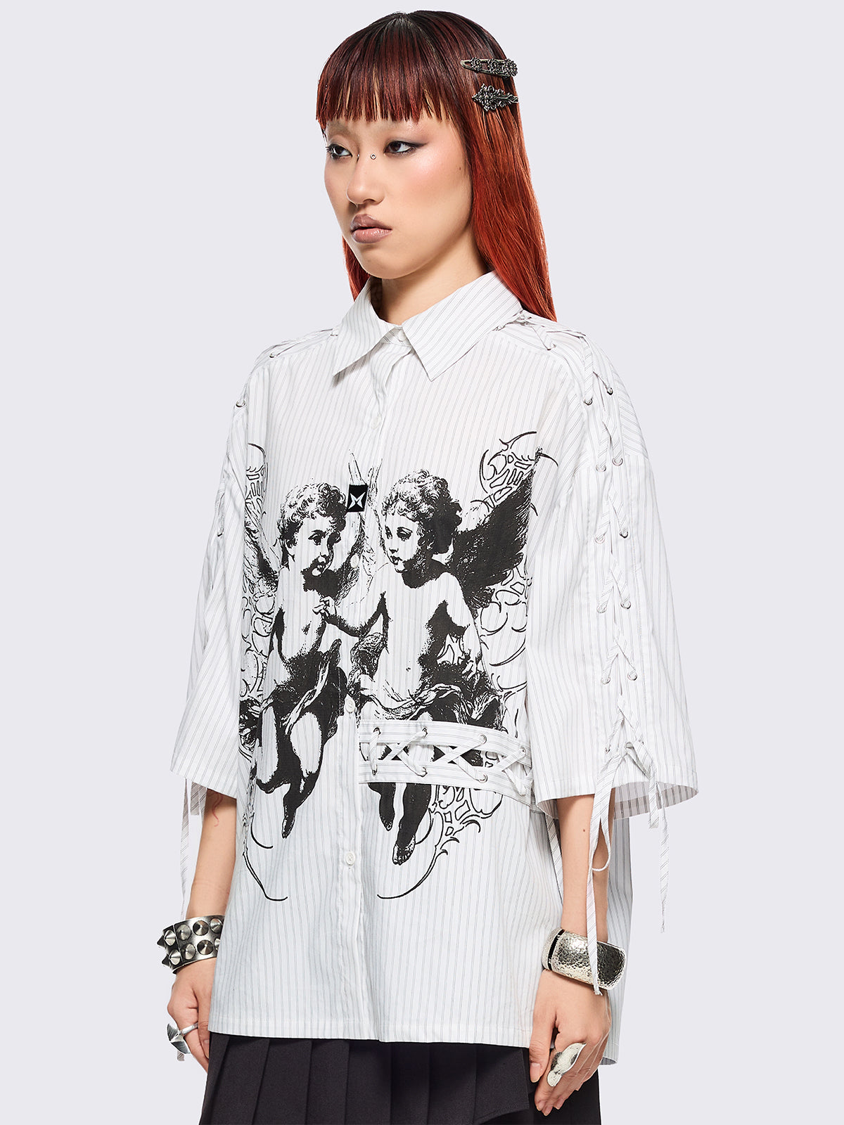 White striped short sleeve shirt featuring a black angels graphic front print and laced up details.