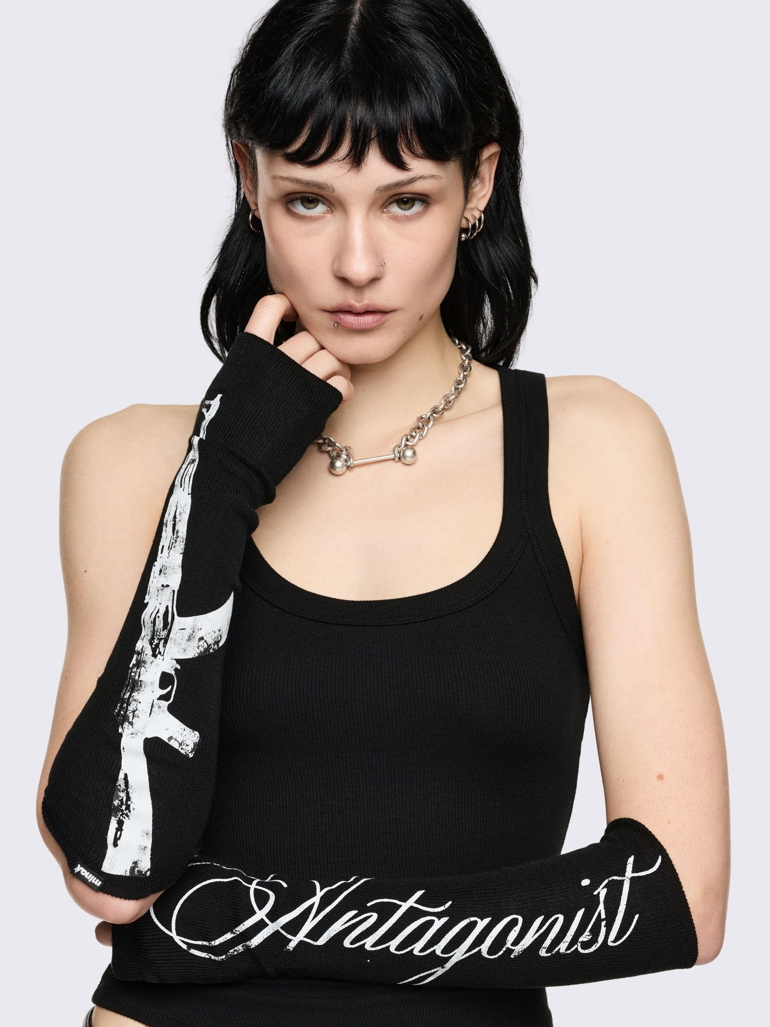 Black arm warmers with "Antagonist" gun graphic print