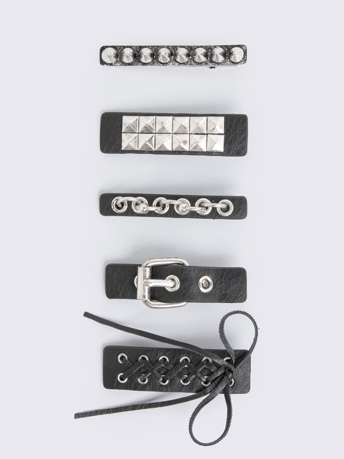 Set of 5 black PU hair clips featuring lace up, buckle, spike, stud and more hardware details. 