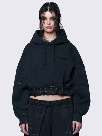 Cropped washed black hoodie with a detachable buckle belt at the hem, an embroidered logo on the chest, raglan sleeves, and a drawstring hood. Stylish and comfortable.