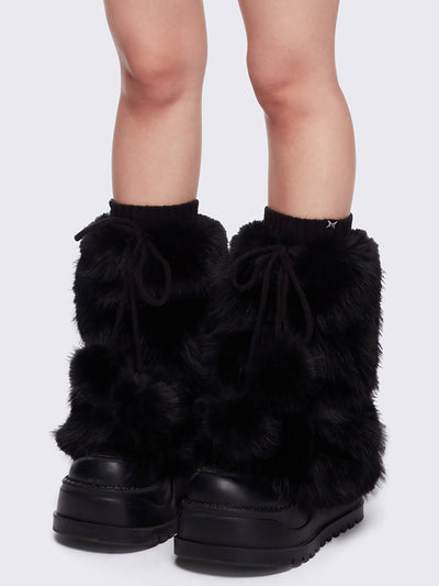 Black faux fur flared leg warmers with pom pom drawstring.