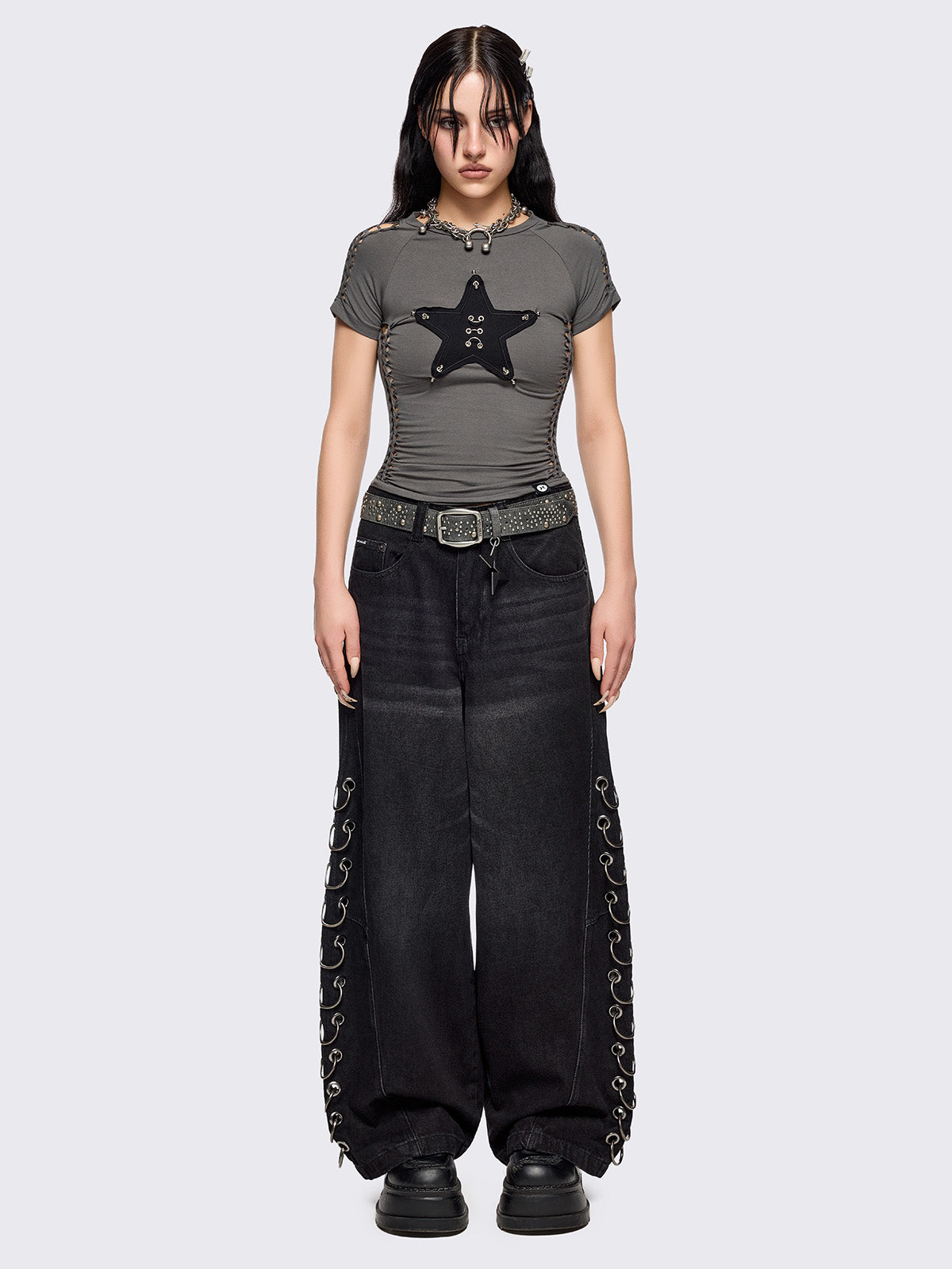 Grey slitweave baby tee with black front star patch with piercings.