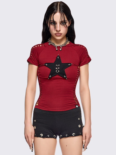 Red slitweave baby tee featuring a black front star patch with piercings.