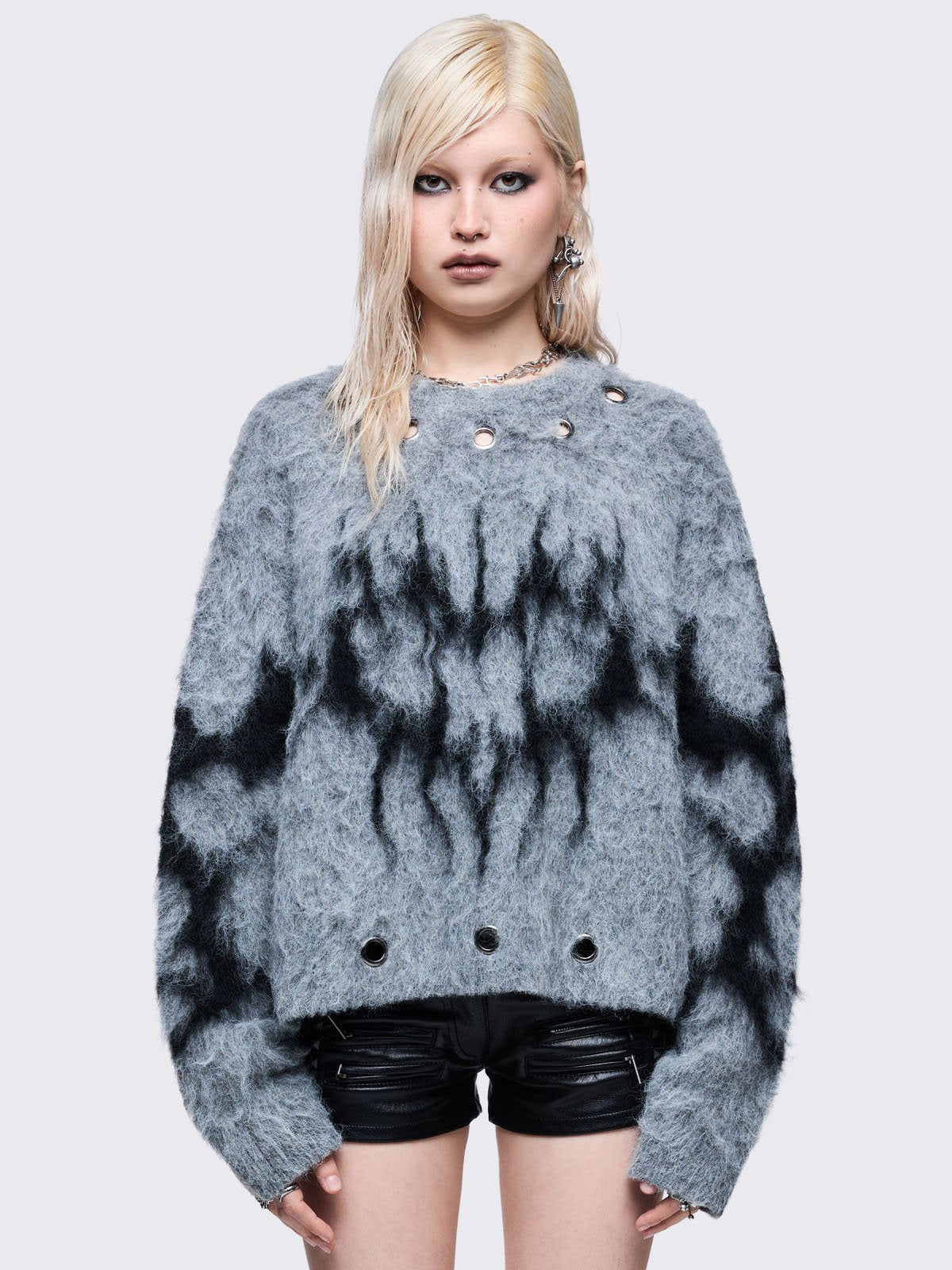 Grey knitted jumper with black sigil heart design and chunky silver eyelet details.
