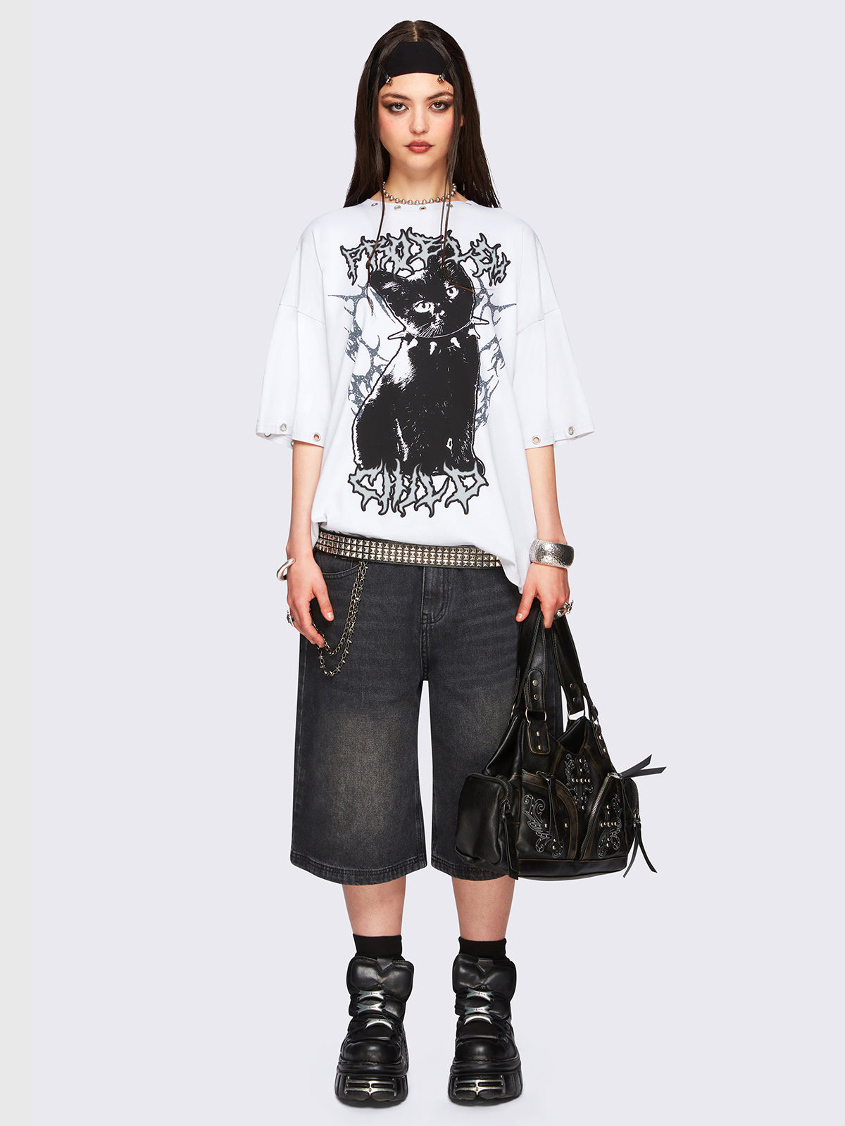 Off-white oversized t-shirt with black kitty graphic front print and eyelet neckline and hem details.