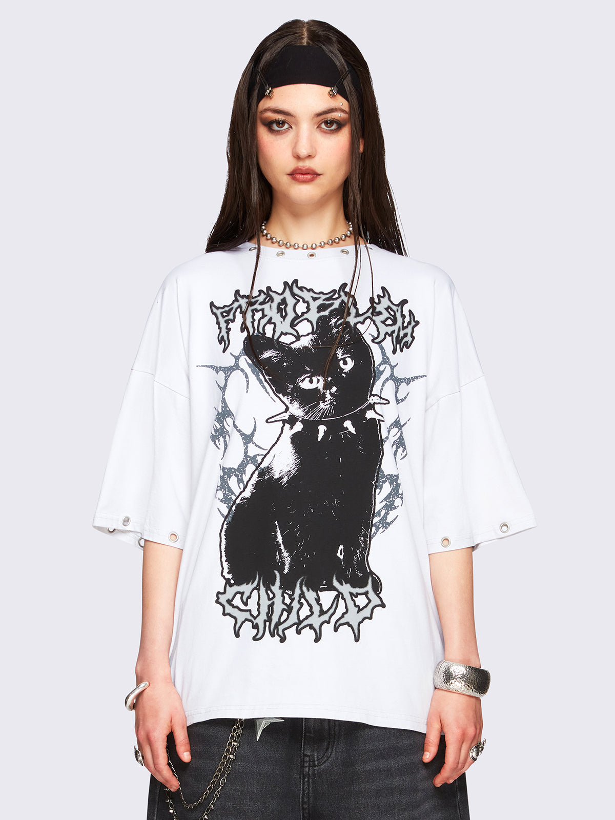 Off-white oversized t-shirt with black kitty graphic front print and eyelet neckline and hem details.