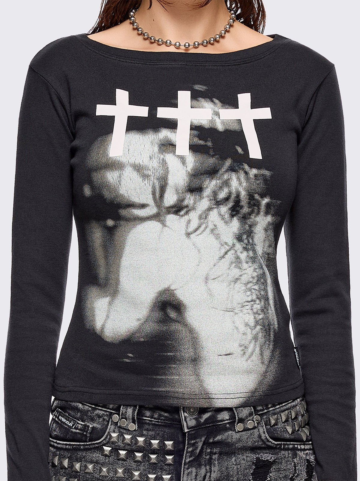 Black long sleeve top with grunge graphic and crosses graphic front print.