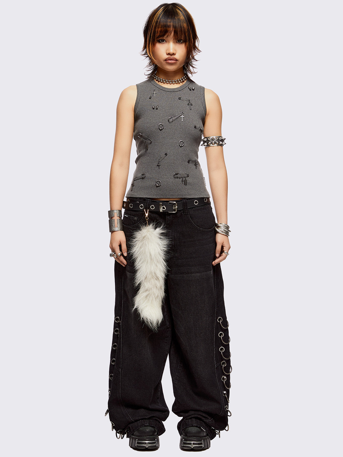 Black washed super baggy jeans with silver chunky eyelets along sides with O-rings. Oversized fit.