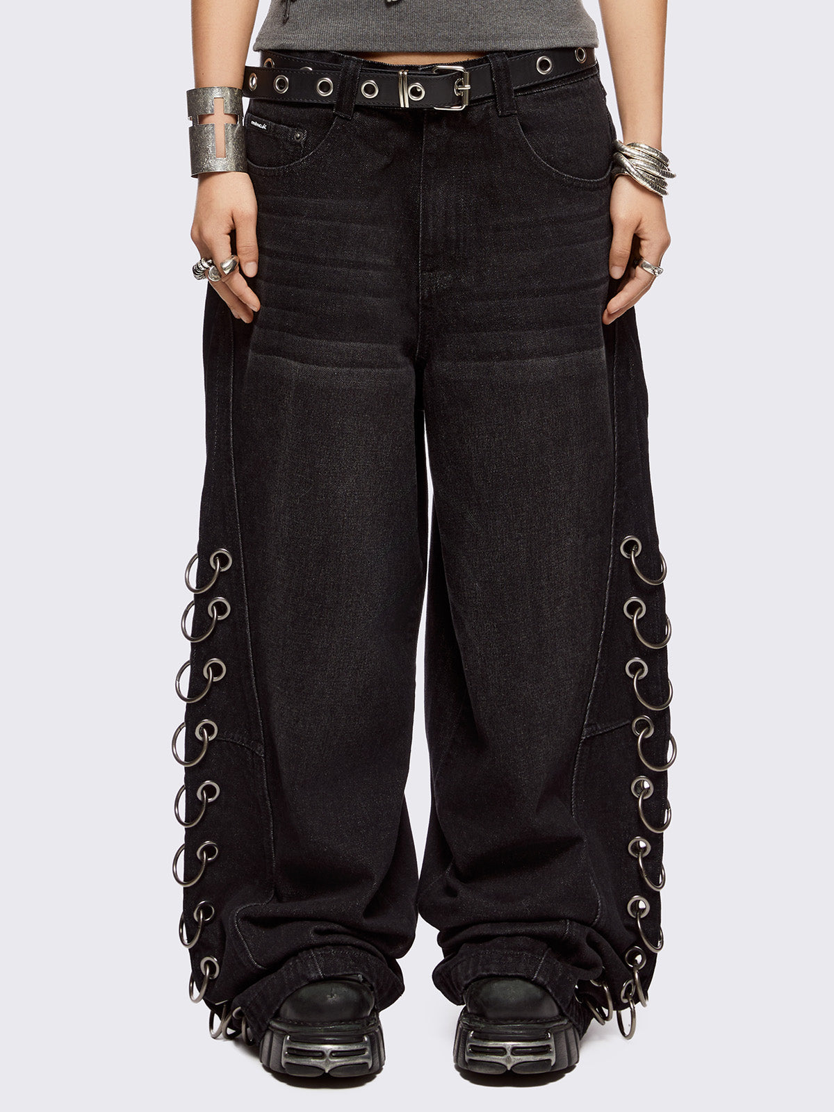 Black washed super baggy jeans with silver chunky eyelets along sides with O-rings. Oversized fit.