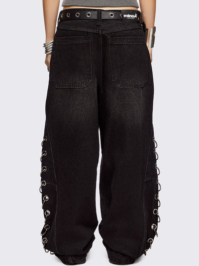 Black washed super baggy jeans with silver chunky eyelets along sides with O-rings. Oversized fit.