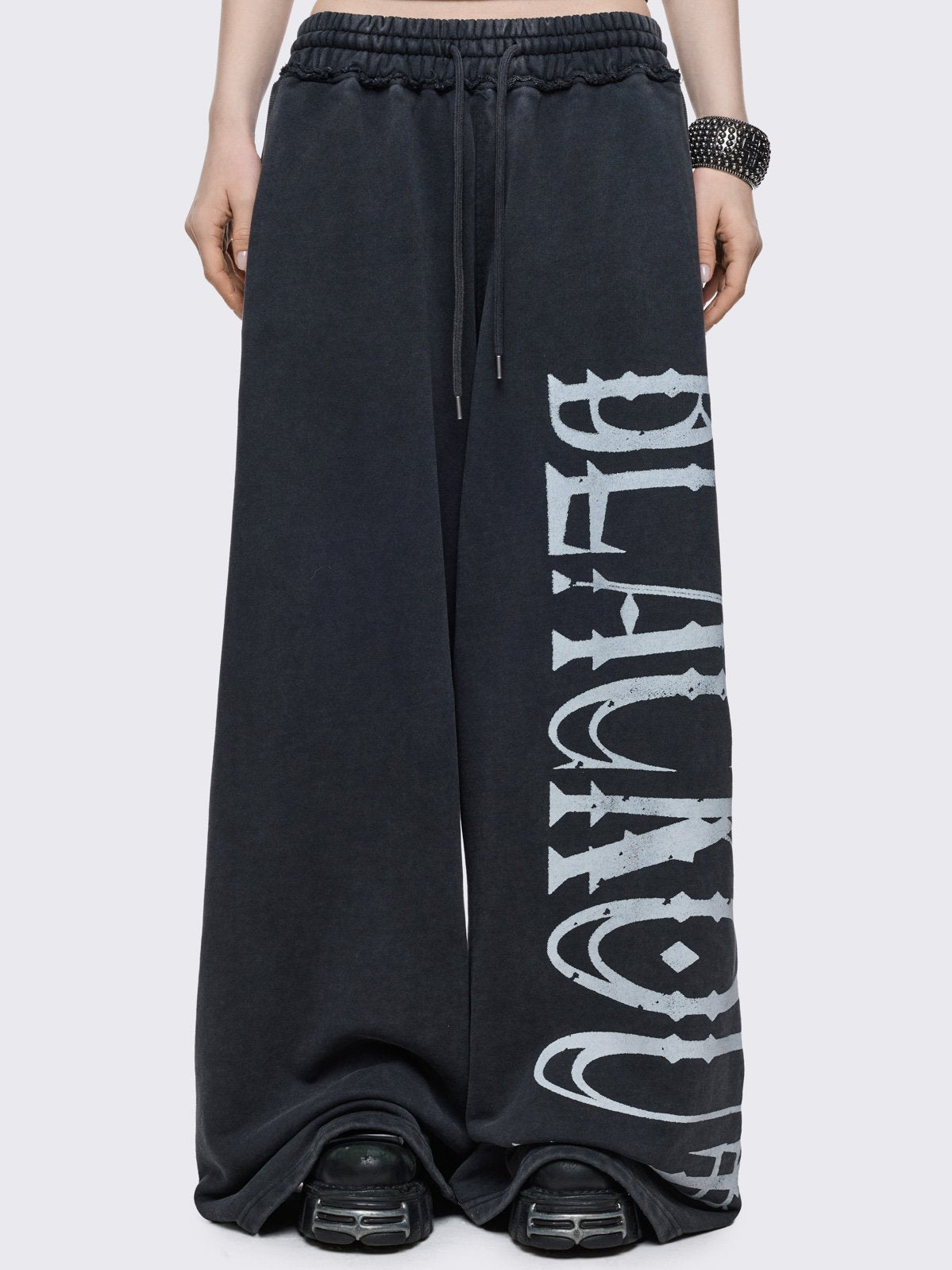 Grey washed sweatpants with "blackout" graphic side print in white.