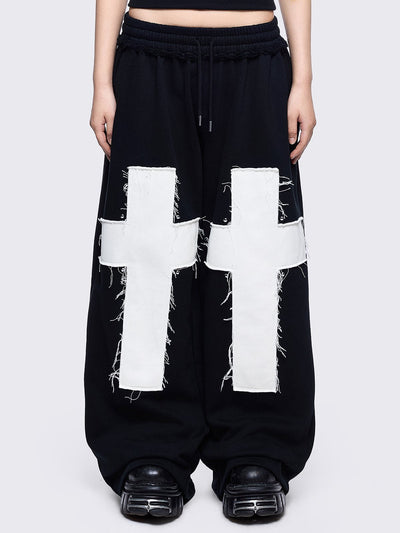 Black sweatpants with white chunky cross patches