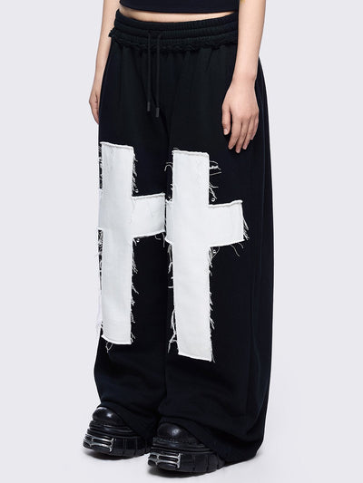 Black sweatpants with white chunky cross patches