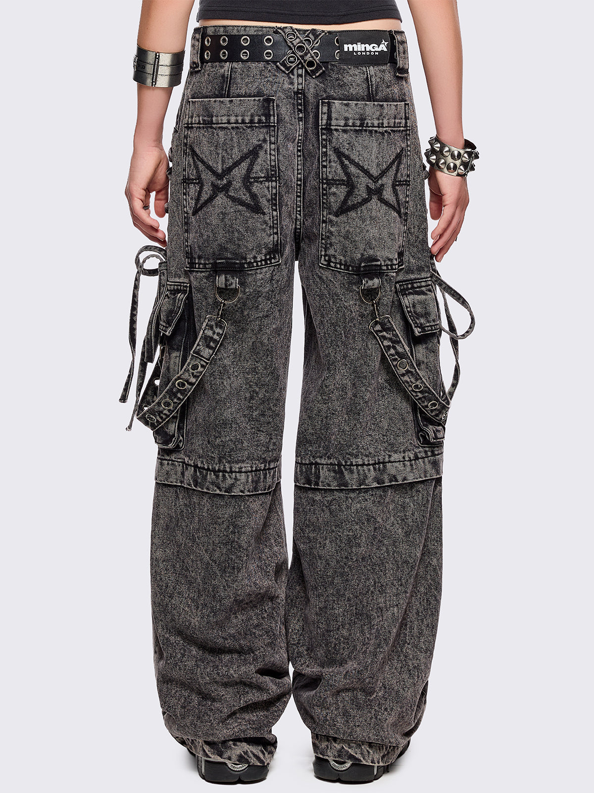 Grey acid washed multi pocket cargo jeans featuring a detachable-leg with zipper and all over strap, D-ring and lace up details.