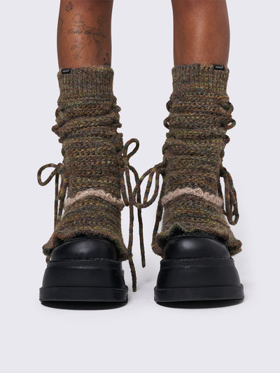 Boho crochet flared leg warmers featuring a space-dye design, lace up and ruffles details.