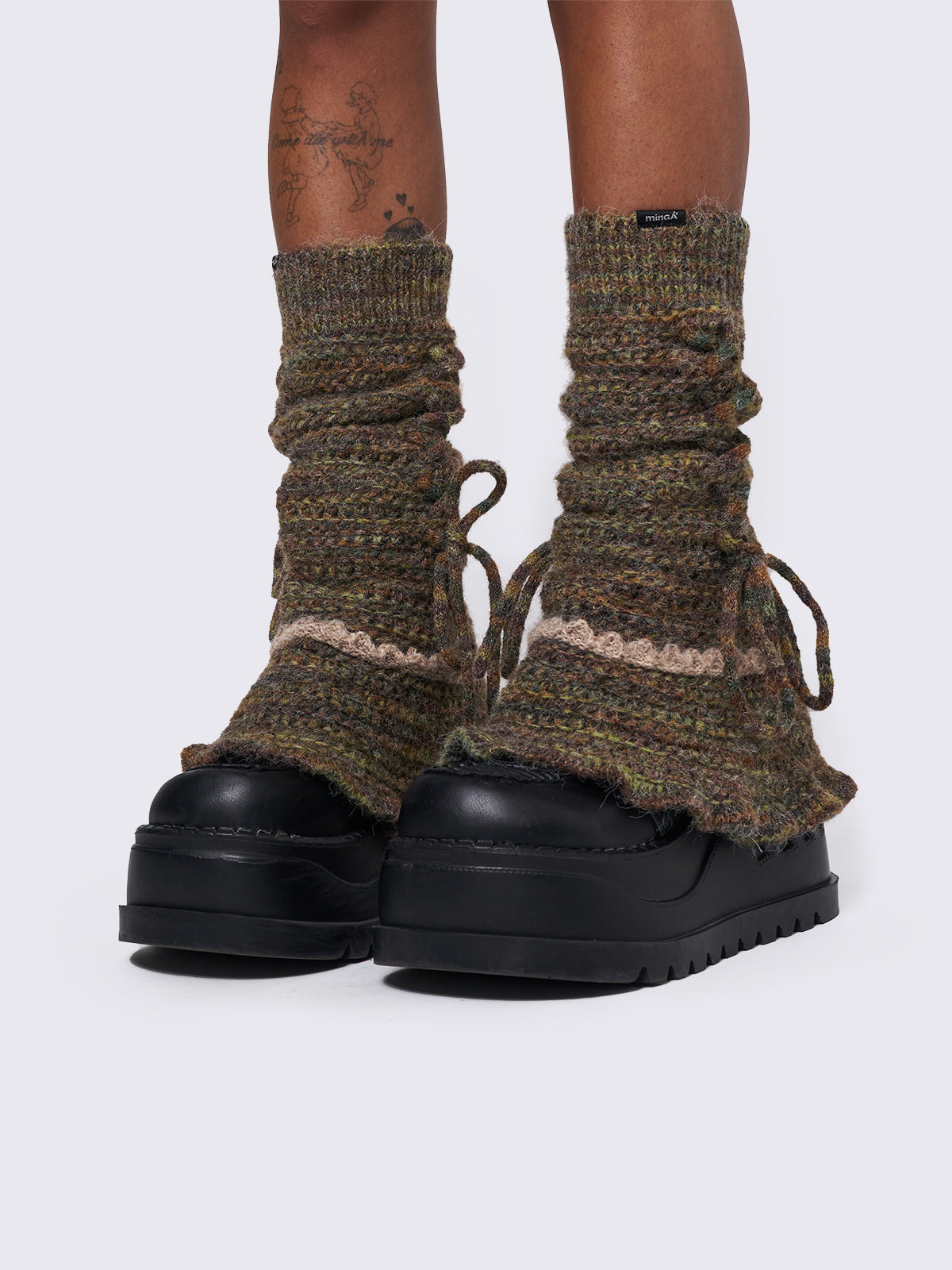 Boho crochet flared leg warmers featuring a space-dye design, lace up and ruffles details.