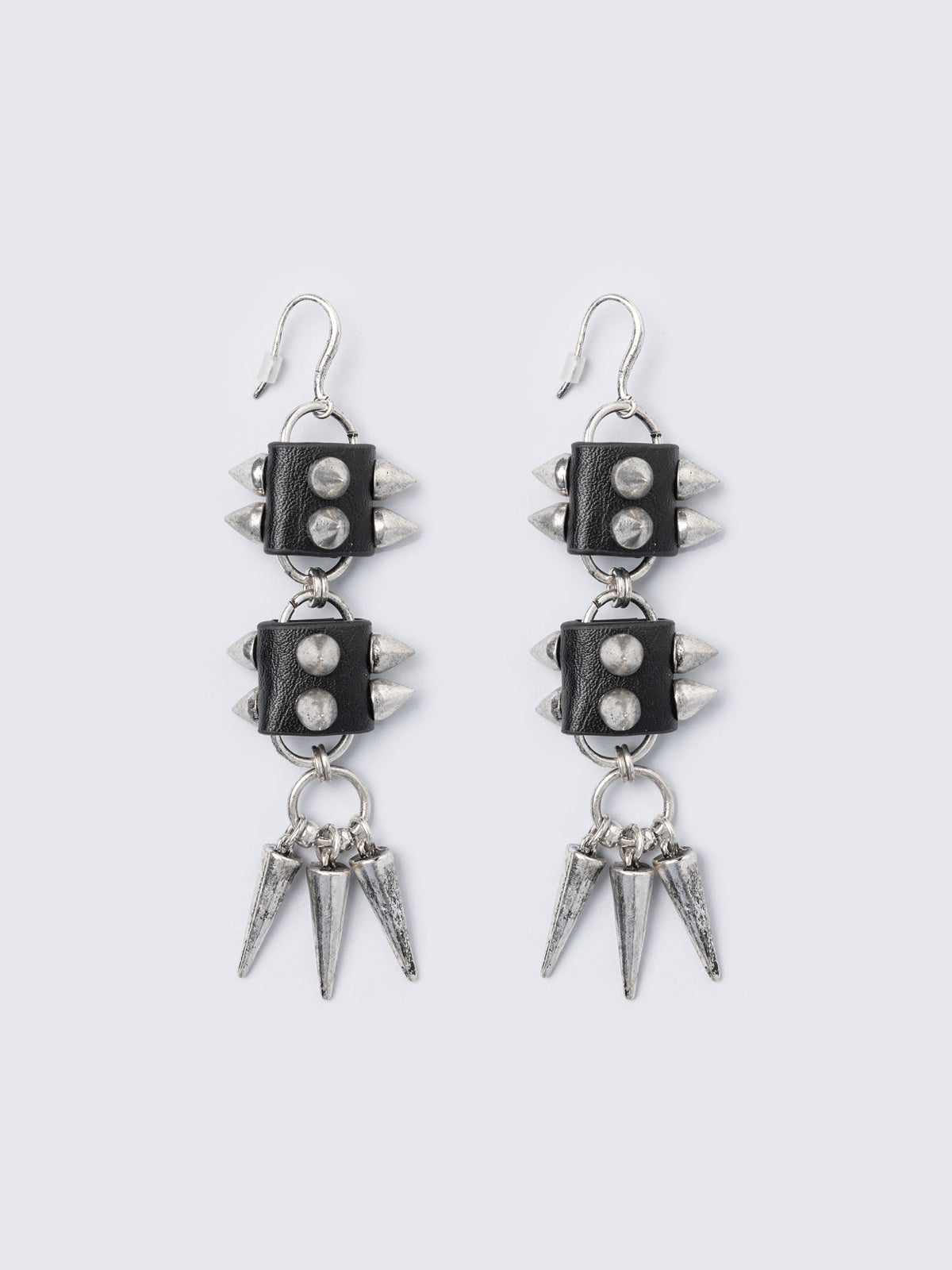 Silver dangle earrings with spiked pendants and black faux leather details