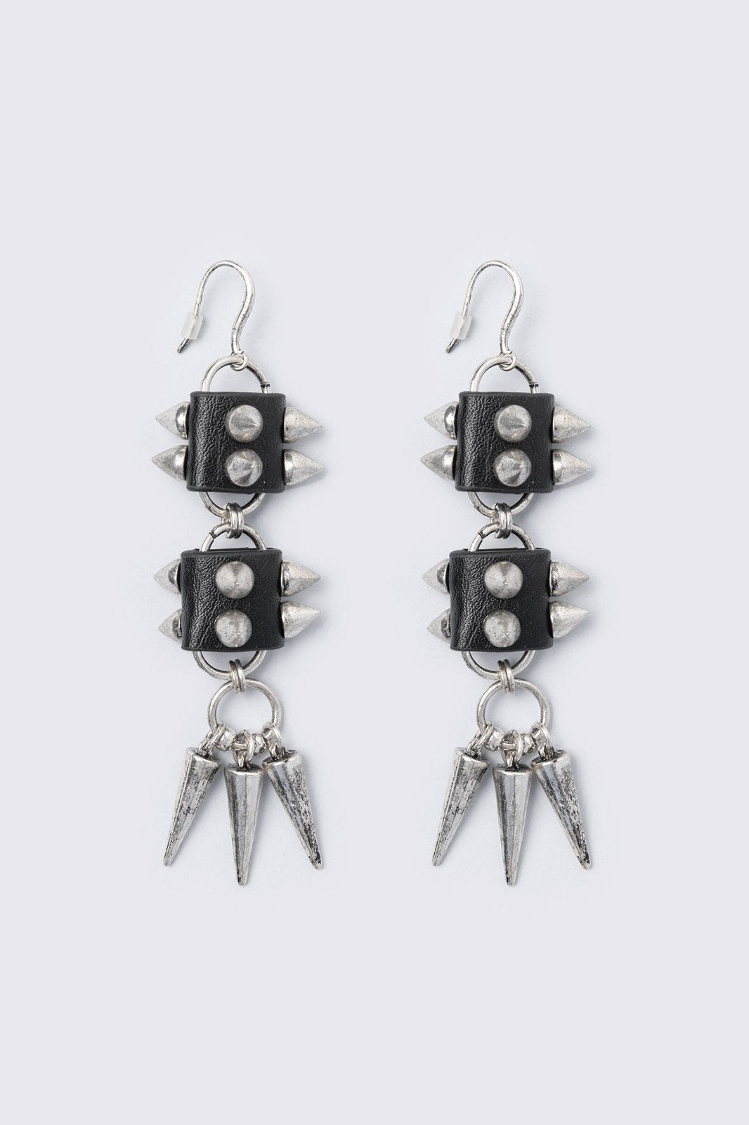 Silver dangle earrings with spiked pendants and black faux leather details