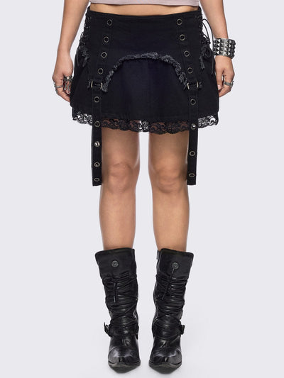 Black denim mini skirt with distressed frayed panels, lace up side details and eyelet straps.
