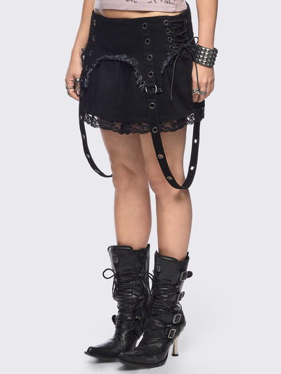 Black denim mini skirt with distressed frayed panels, lace up side details and eyelet straps.