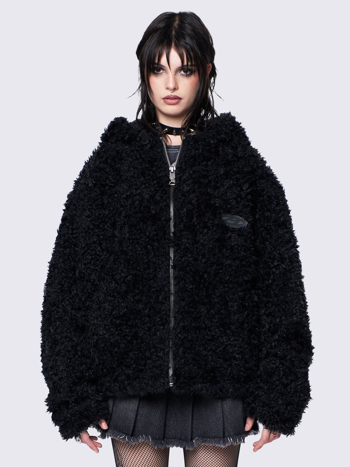 Black fuzzy zip-up jacket with bunny ear hood, oversized fit, and soft faux fur texture. 