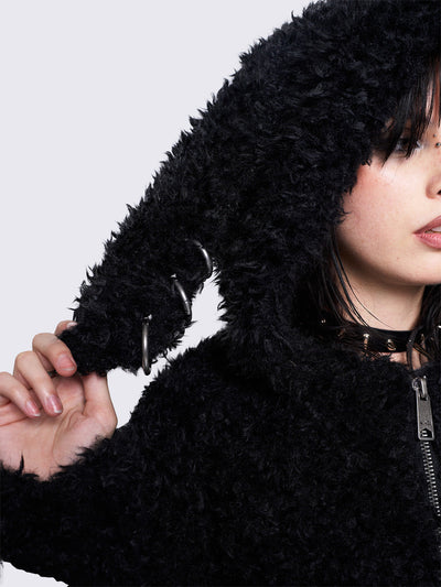 Black fuzzy zip-up jacket with bunny ear hood, oversized fit, and soft faux fur texture. 