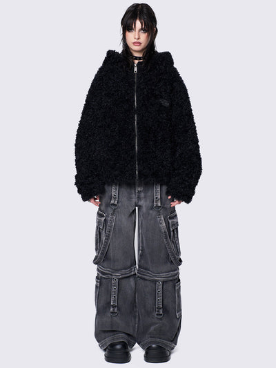 Black fuzzy zip-up jacket with bunny ear hood, oversized fit, and soft faux fur texture. 