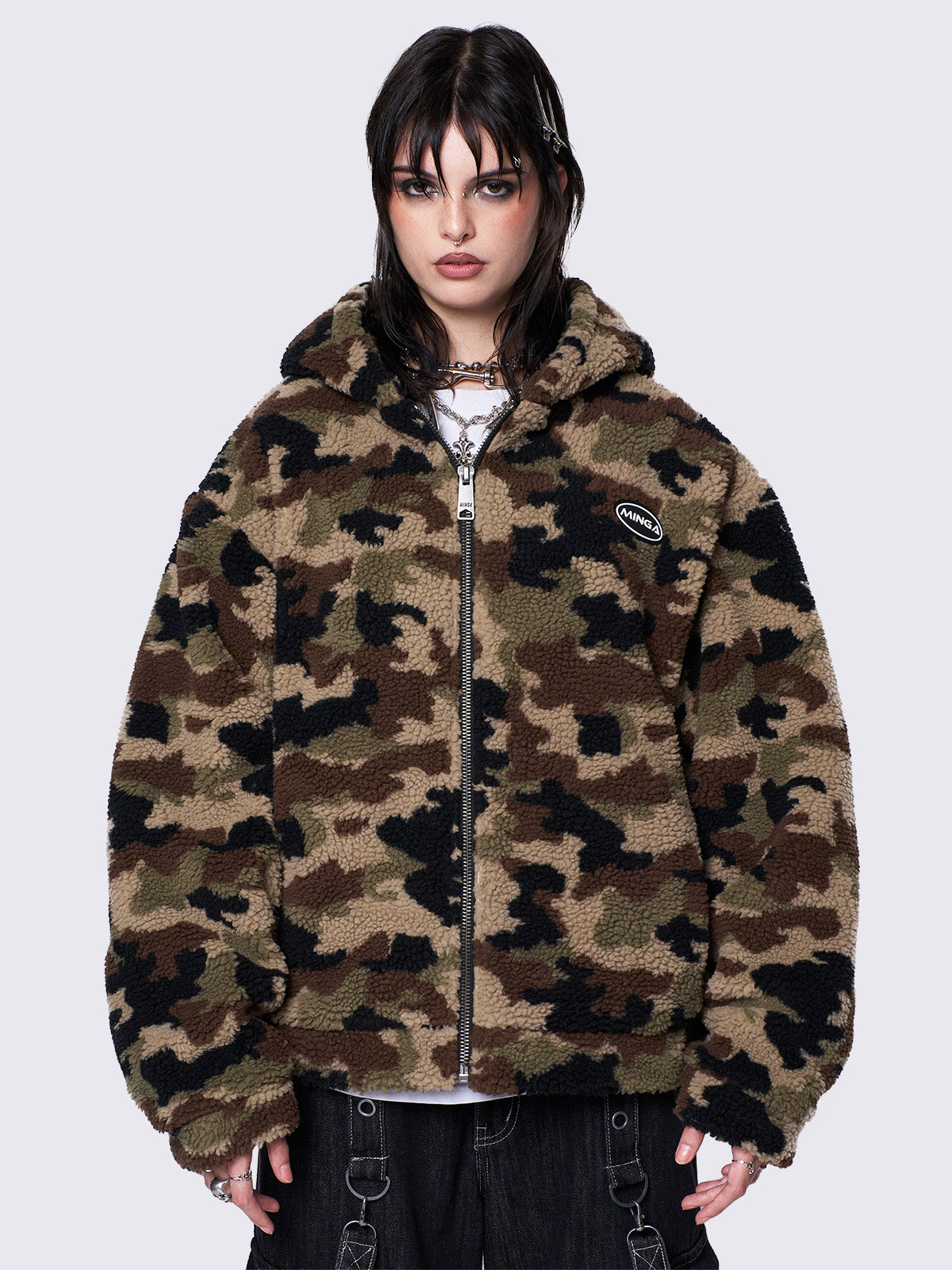 Oversized zip-up borg fleece jacket with camo print, featuring a hood, oversized fit, and embroidered logo patch. Ideal for grunge and Y2K-inspired streetwear.