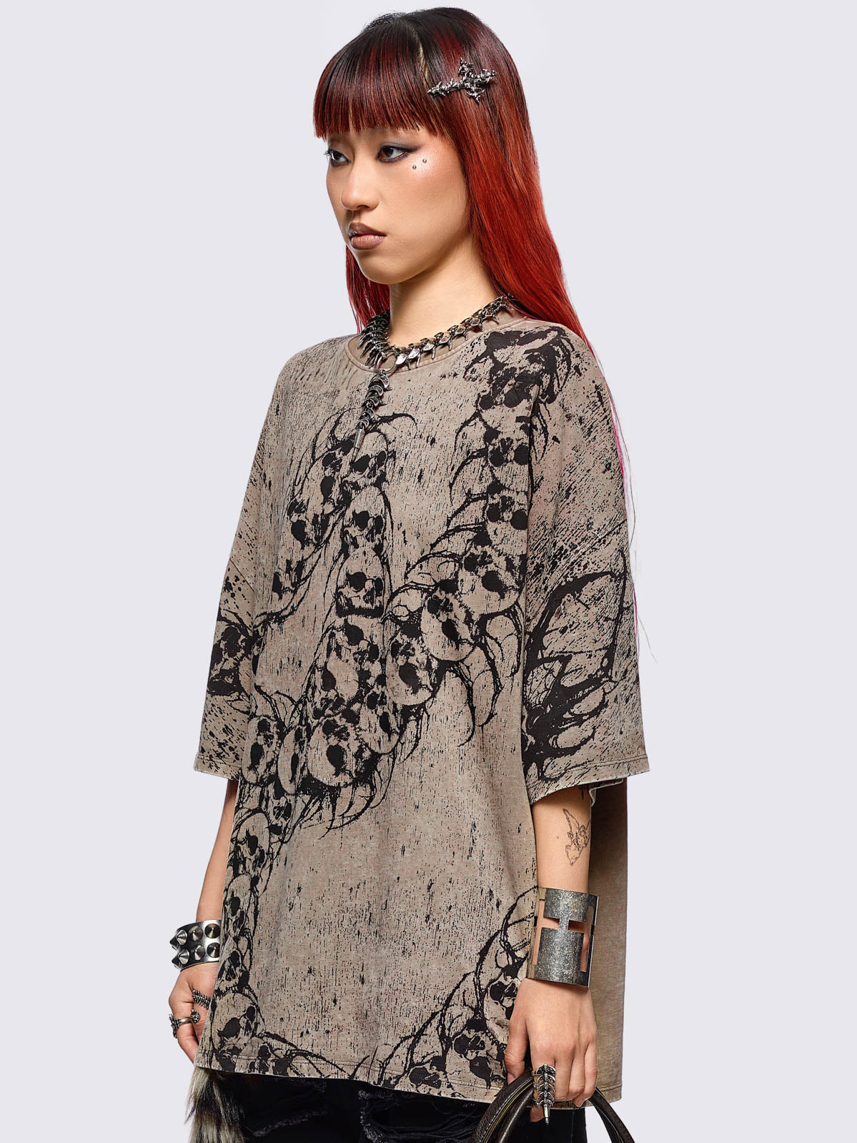 Beige oversize washed t-shirt featuring a skull centipede graphic front print.