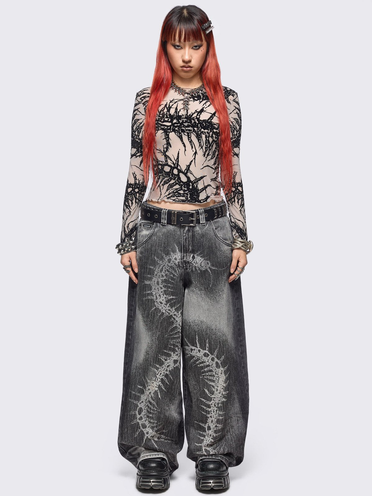 Beige mesh top with black centipede graphic print.