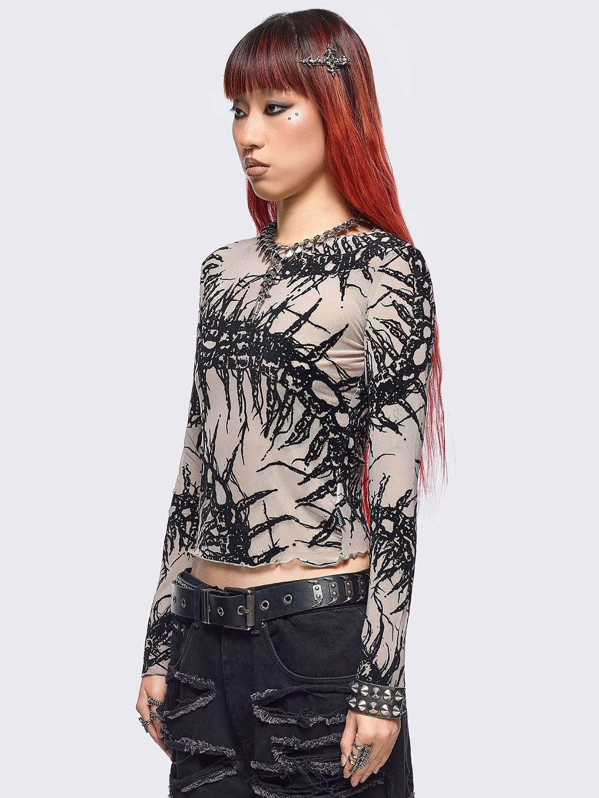 Beige mesh top with black centipede graphic print.