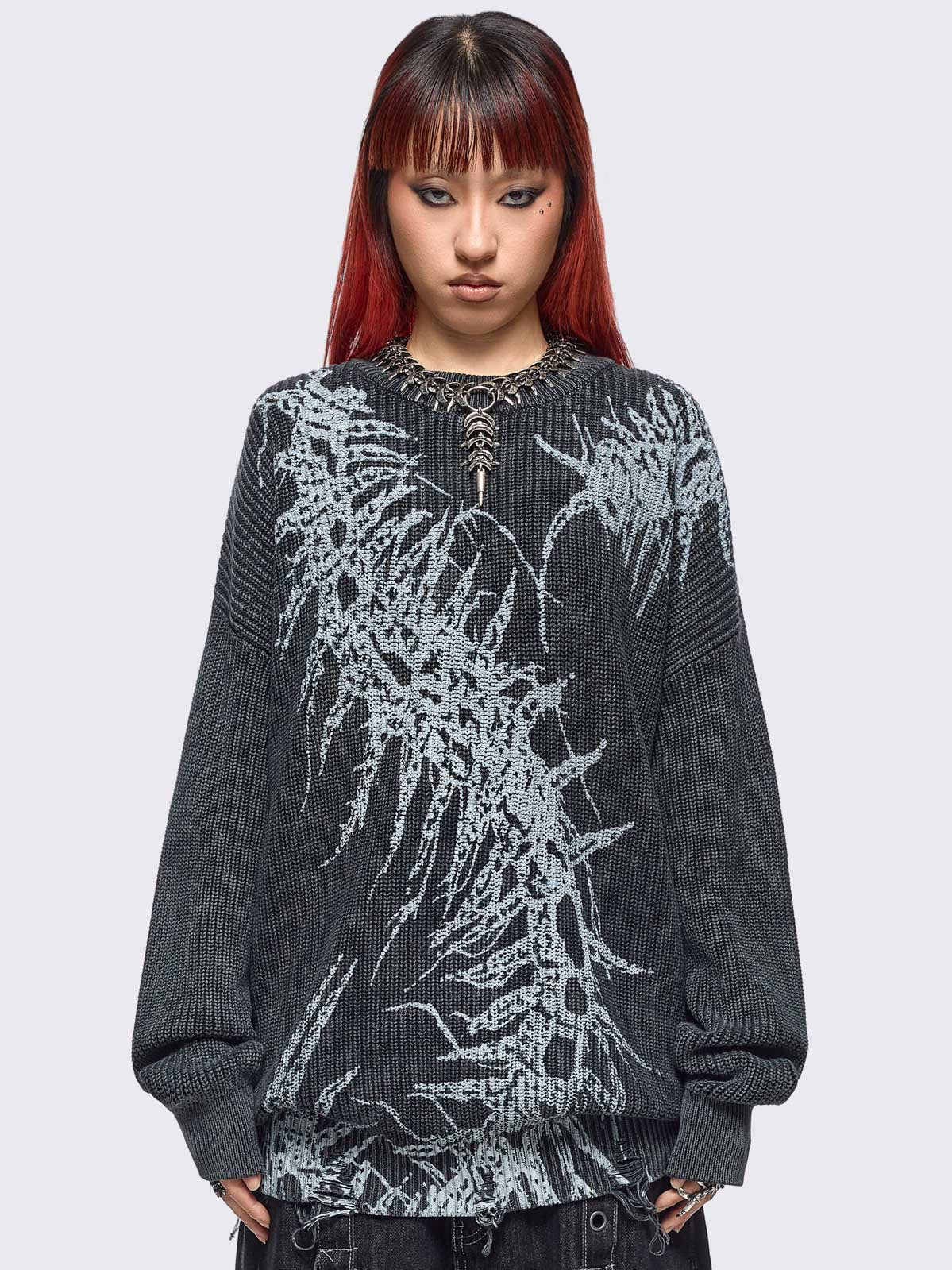 Black washed knit jumper in chunky ribbed knit with centipede graphic front print and distressed hem details. 