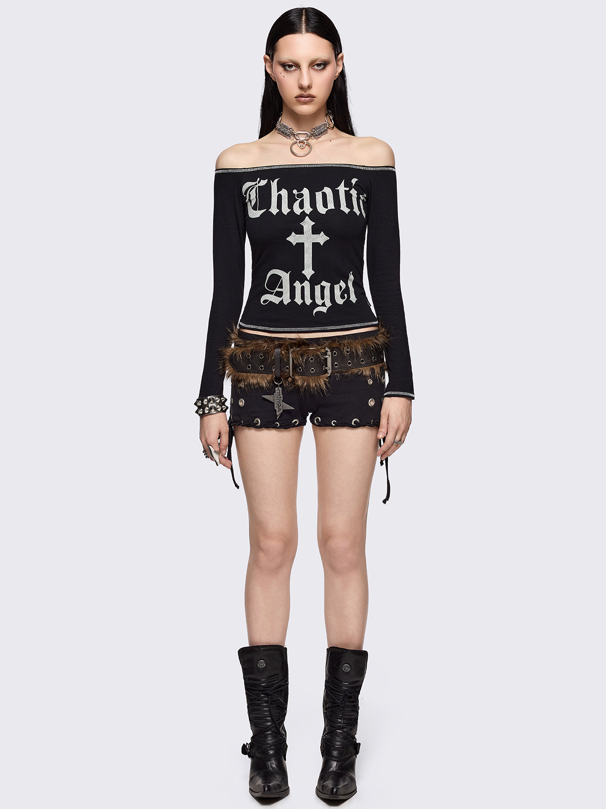 Black off-shoulder top with "Chaotic Angel" cross front print and white contrast stitches.
