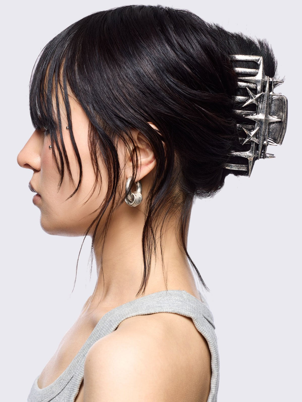 Metal hair claw clip with stars design.