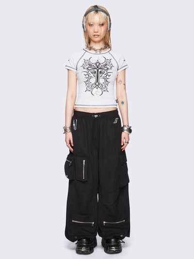 Off-white graphic raglan baby tee with tribal cross print and black contrast stitching.