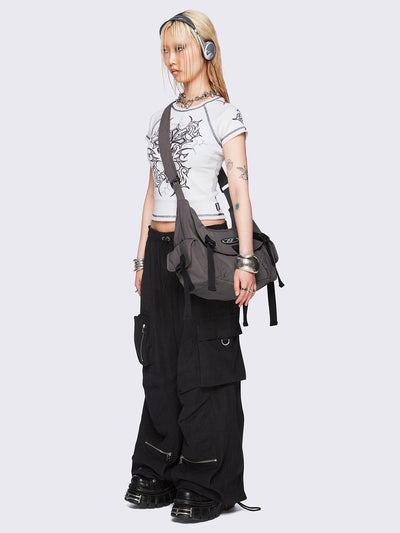 Off-white graphic raglan baby tee with tribal cross print and black contrast stitching.