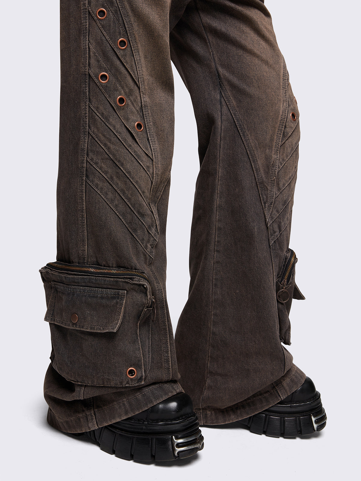 Grey washed flare baggy jeans with brown overdye, twist seam, eyelet details and utility ankle pockets.