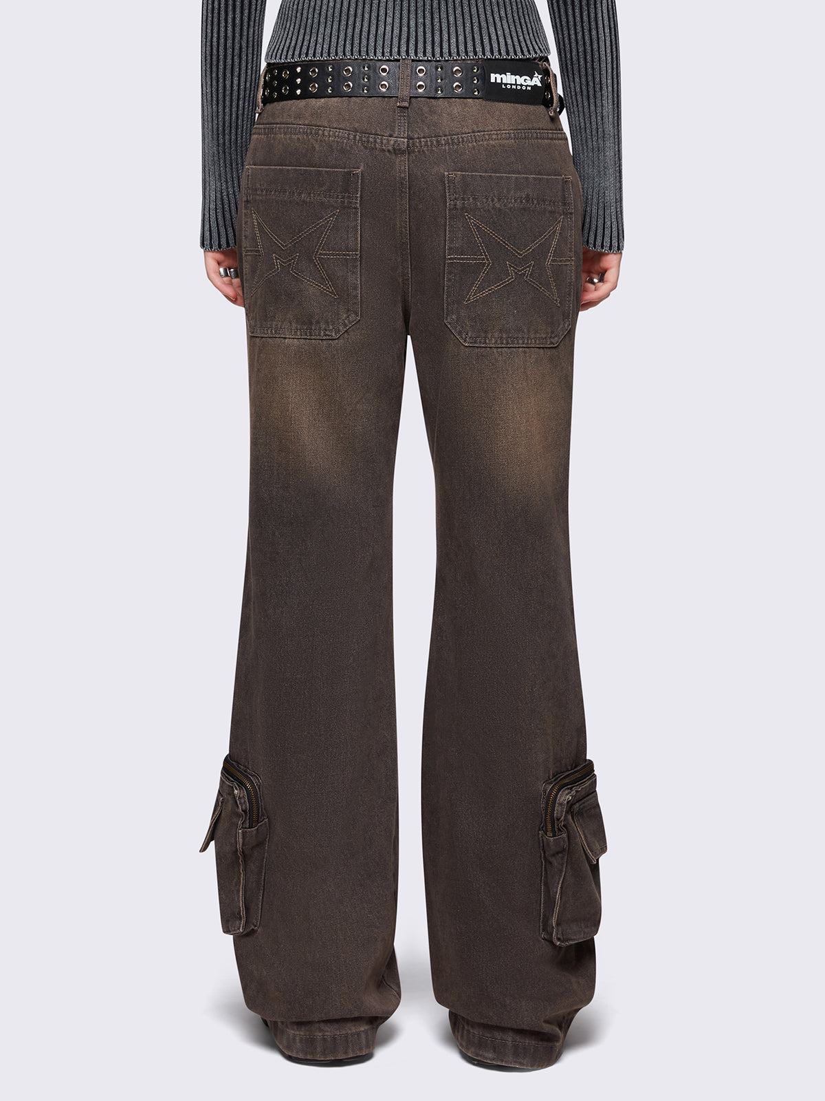 Grey washed flare baggy jeans with brown overdye, twist seam, eyelet details and utility ankle pockets.