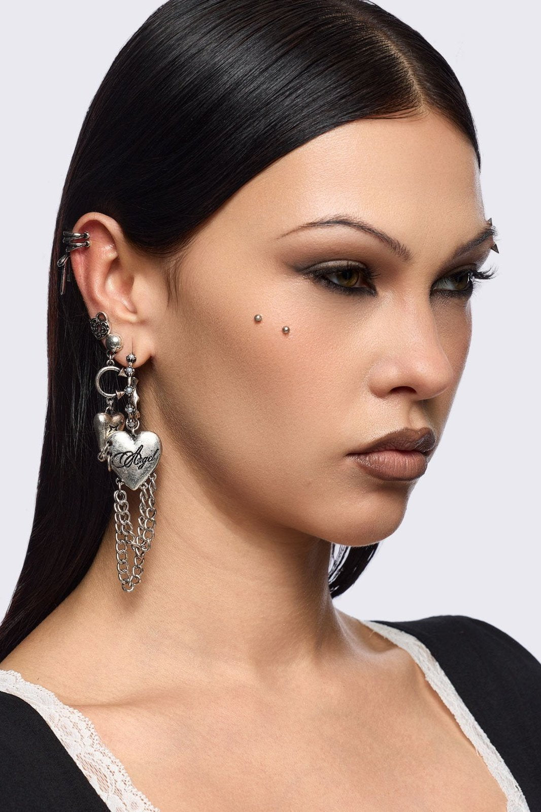 Silver 4pc layering earring set featuring heart and tooth pendant in chunky hoops, studs and ear cuff style.