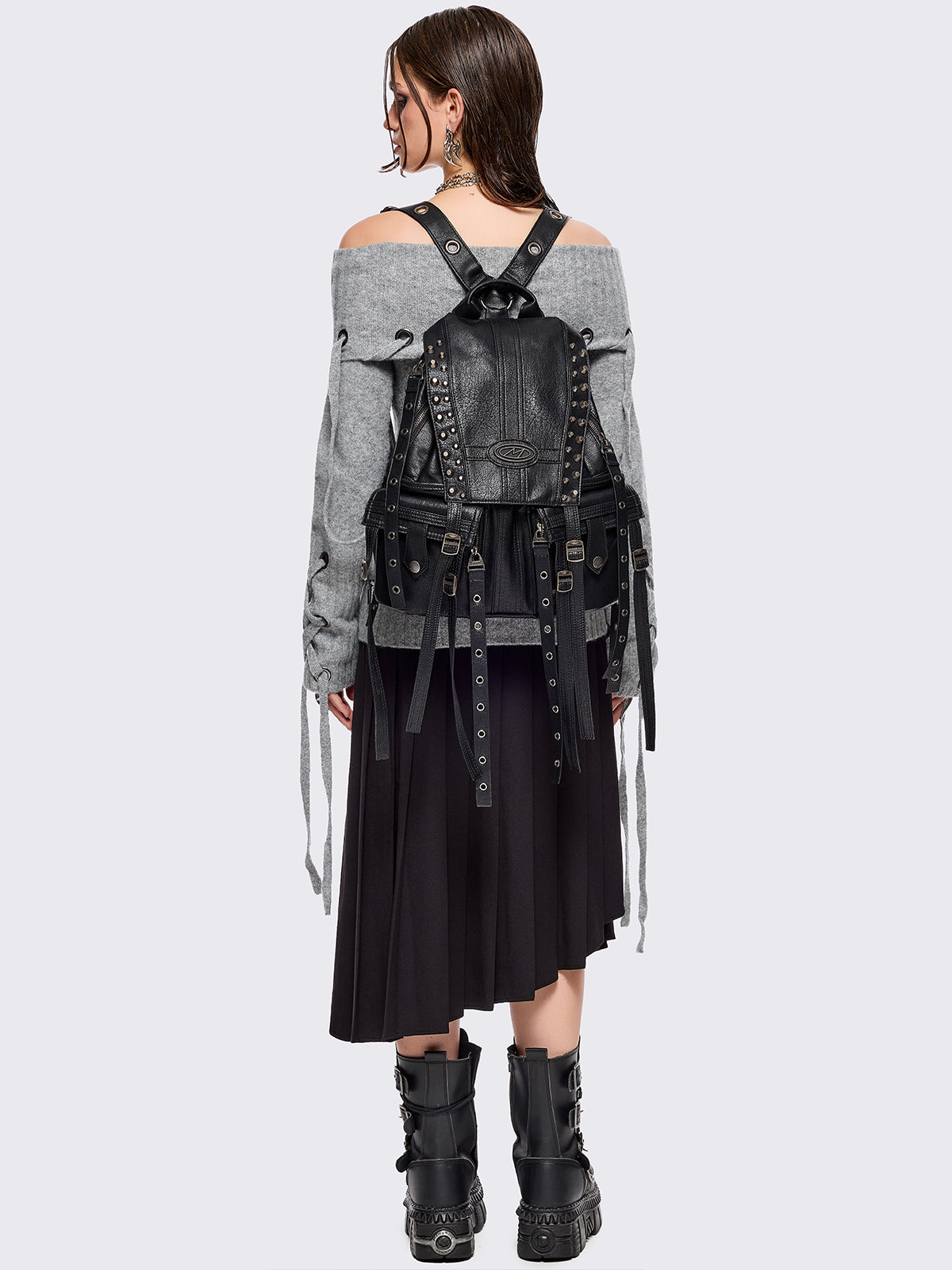 Black vegan leather backpack featuring silver stud, eyelet and strap details.
