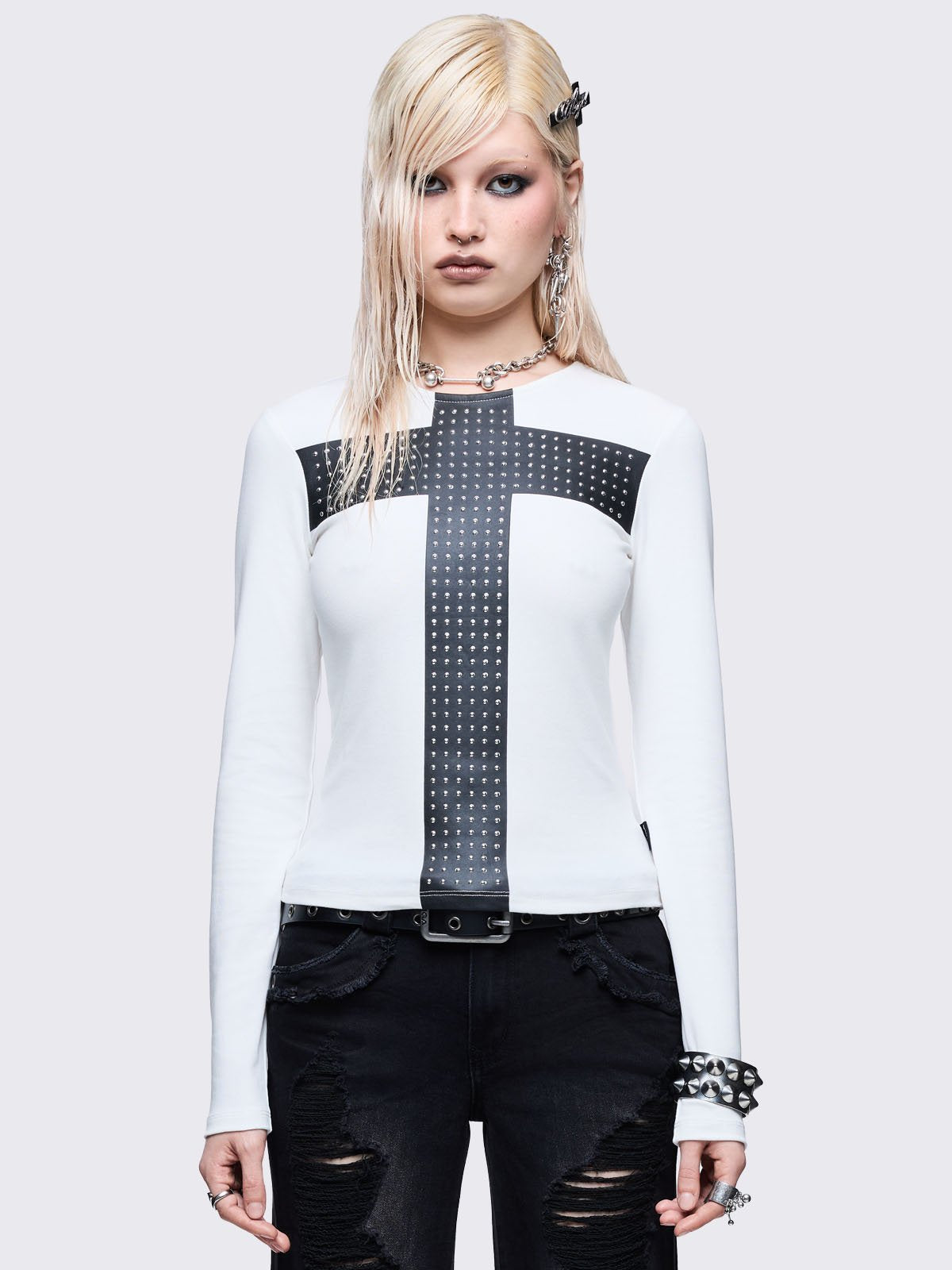 White long sleeve top with black chunky cross with silver studs