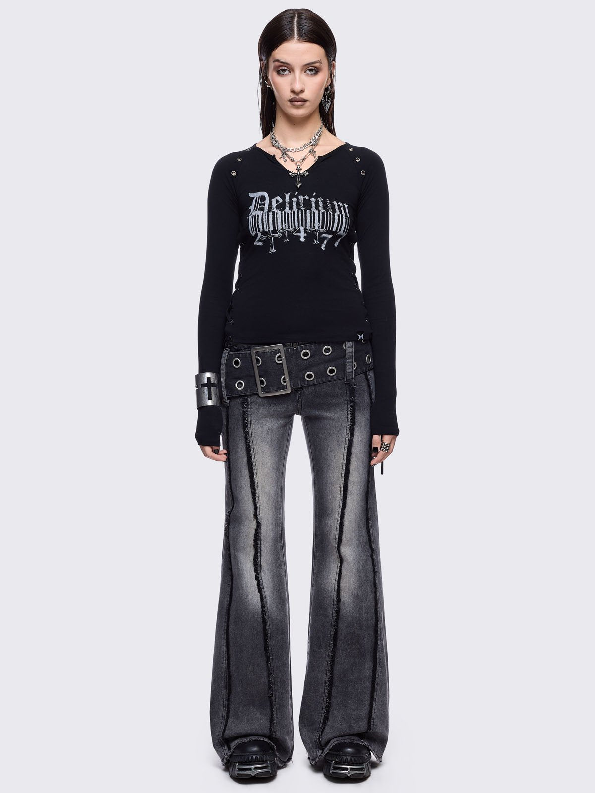 Black long sleeve top with "delirium" graphic front print, lace-up sides and silver eyelet details. 