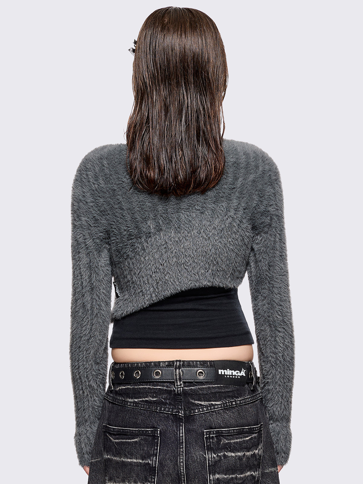 Grey fuzzy knitted sweater with cut-outs with metal ring hardware details.
Bolero asymmetric style.
