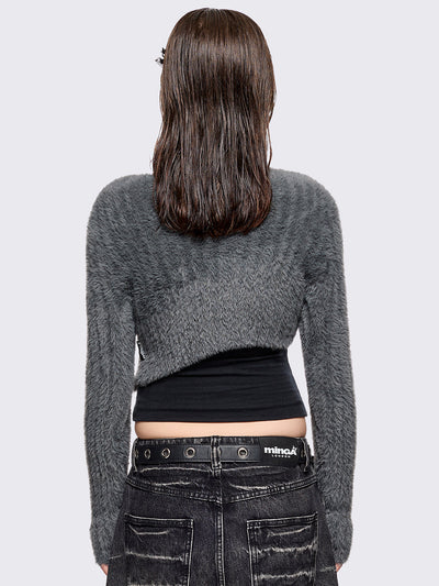 Grey fuzzy knitted sweater with cut-outs with metal ring hardware details.
Bolero asymmetric style.